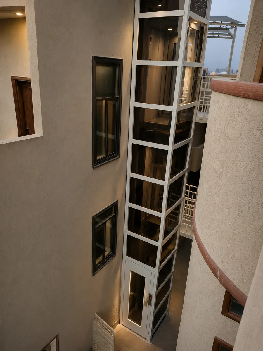 Modern steel and glass elevator installed in a Pakistani home